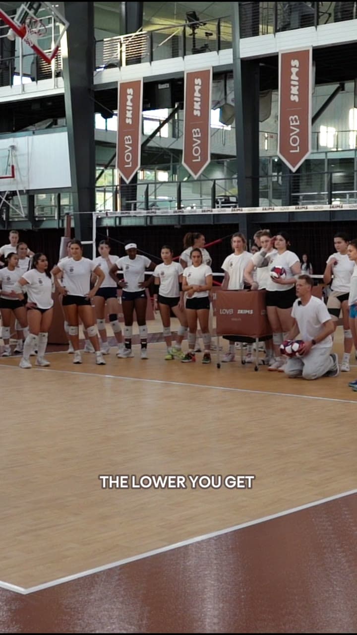 A LOVB x SKIMS volleyball clinic, coach and players on court under LOVB and SKIMS banners
